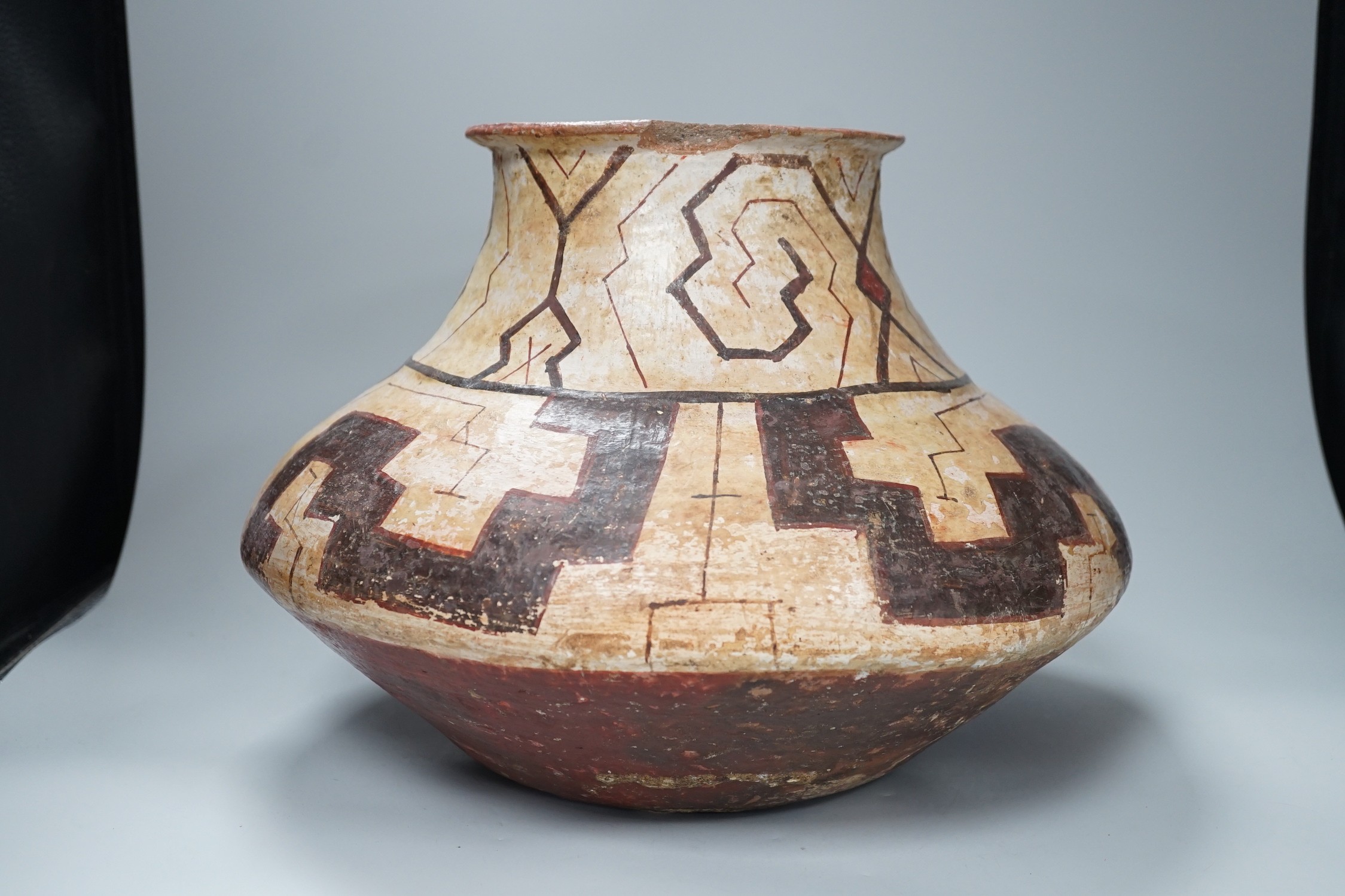 A Shipibo pottery water vessel with geometric pattern, Peru, 26cm tall